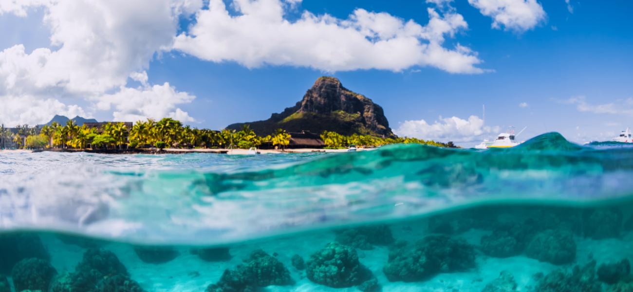 Blue ocean underwater and Le Morne mountain in Mauritius.