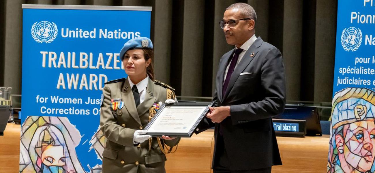 Major Ahlem Douzi is presented with the United Nations Trailblazer Award by Chef de Cabinet Courtenay Rattray at a special ceremony.