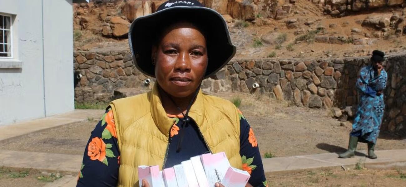 A Village Health Worker holds a pack of oral contraceptives at a health facility in Mokhotlong, where community-based distribution plays a vital role in improving access to family planning services.