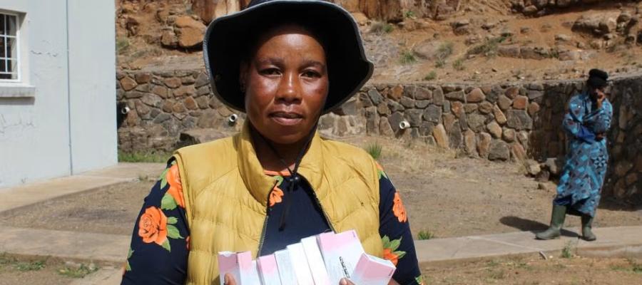 A Village Health Worker holds a pack of oral contraceptives at a health facility in Mokhotlong, where community-based distribution plays a vital role in improving access to family planning services.
