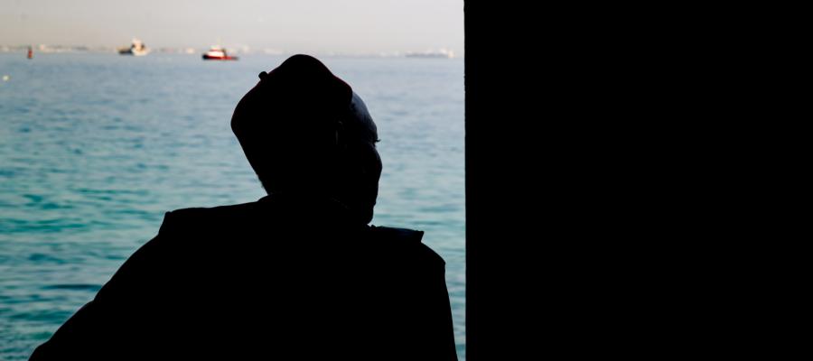 A man looks out to sea from the Door of No Return on Gorée Island, Senegal—a solemn memorial to the millions of Africans taken from their homeland during the transatlantic slave trade. The island stands today as a symbol of remembrance and resilience.