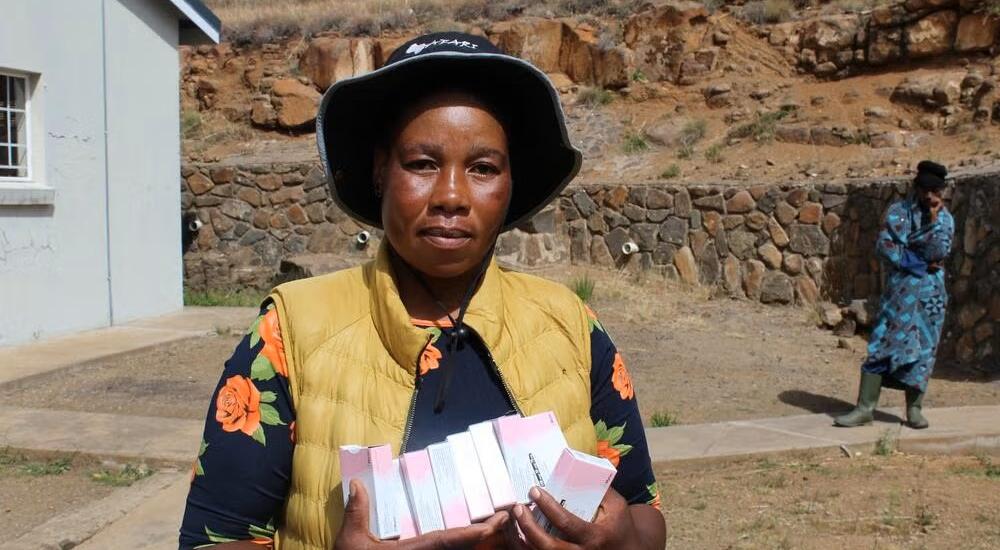 A Village Health Worker holds a pack of oral contraceptives at a health facility in Mokhotlong, where community-based distribution plays a vital role in improving access to family planning services.
