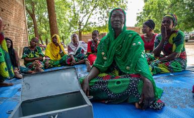 Zara Ellie, a dedicated mother and entrepreneur, leading the 'Hanoune' Savings and Internal Lending Community meeting in Koudoul, Chad, where members unite to foster financial growth and solidarity.