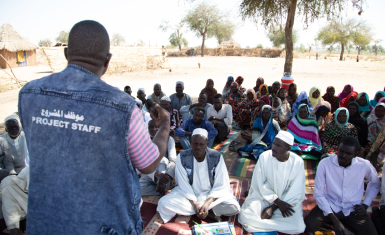 CRS staff addressing the community in Hashaba village, West Darfur, Sudan.