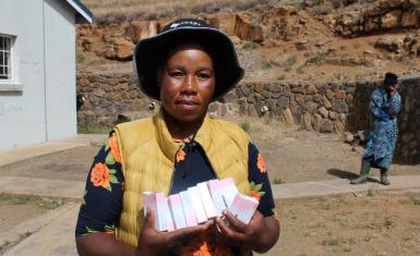A Village Health Worker holds a pack of oral contraceptives at a health facility in Mokhotlong, where community-based distribution plays a vital role in improving access to family planning services.