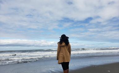 Dena M. Chasten standing on a beach. She found her birth parents and now works as a genealogist.