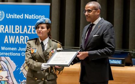Major Ahlem Douzi is presented with the United Nations Trailblazer Award by Chef de Cabinet Courtenay Rattray at a special ceremony.