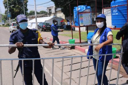 IOM staff stand ready to supervise COVID-19 preventive measures activities at a point of control in Kinshasa, Democratic Republic of the Congo.