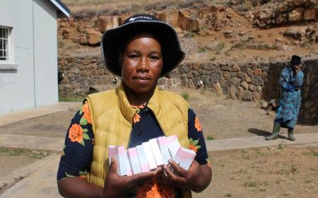 A Village Health Worker holds a pack of oral contraceptives at a health facility in Mokhotlong, where community-based distribution plays a vital role in improving access to family planning services.
