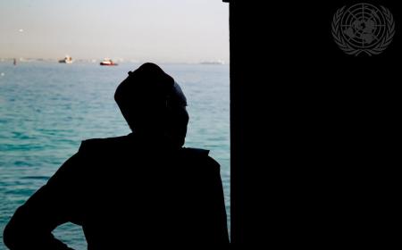 Un homme regarde la mer depuis la Porte du non-retour sur l'île de Gorée, au Sénégal, un mémorial solennel dédié aux millions d'Africains arrachés à leur patrie pendant la traite transatlantique des esclaves.  L'île est aujourd'hui un symbole de mémoire et de résilience.