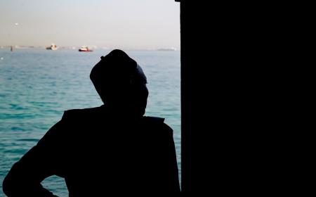 A man looks out to sea from the Door of No Return on Gorée Island, Senegal—a solemn memorial to the millions of Africans taken from their homeland during the transatlantic slave trade. The island stands today as a symbol of remembrance and resilience.