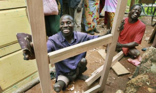 Jonathan Bigirima (left), married and father of six, in his joinery. Photo: Panos/D. Telemans
