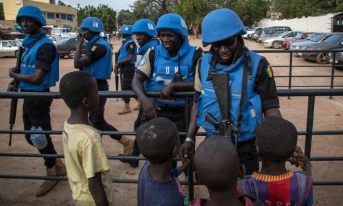 Peacekeepers with the United Nations Multidimensional Integrated Stabilization Mission in Mali (MINUSMA) are greeted by children. Photo: MINUSMA/Marco Dormino
