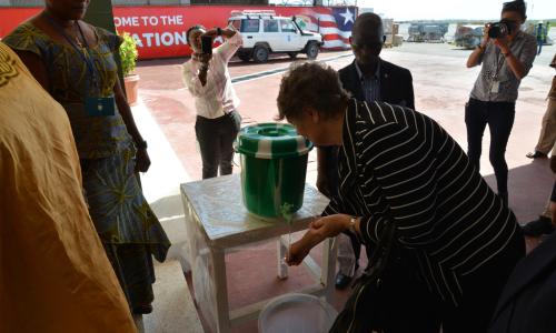 UN Development Program (UNDP) Administrator Helen Clark washes her hands on arrival in Ebola-affected Monrovia, Liberia. Photo: UNDP/Dylan Lowthian