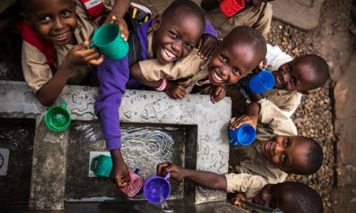 Children fill their cups at a water point built by UNICEF at Kanyosha III primary school in Bujumbura, Burundi. Photo: UNICEF/Rosalie Colfs