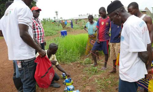 Mobile phones with solar-powered chargers are distributed to all Ebola-quarantined homes in Sella Kafta, Sierra Leone, allowing them to stay in touch with friends and family, which lessens anxiety and resentment.