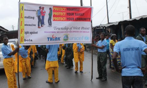 Equipped with UNICEF-developed and Government-approved awareness materials, these girls go door-to-door in West Point, Monrovia, to educate their parents, family members and friends about Ebola and how it can be prevented. Photo: UNICEF/UNI171713/Griggers