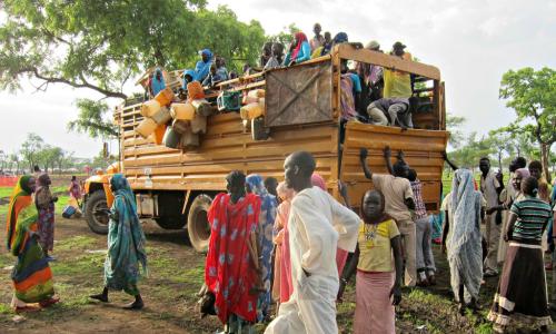 Refugees await unloading at a site in Upper Nile state, South Sudan. Photo: UNHCR/Jake Dinneen