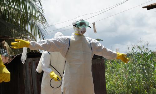 The Ebola burial team gets disinfected and can then remove their personal protective equipment safely.