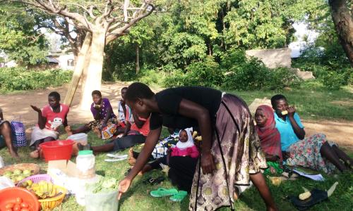 Eunice Achieng Omondi, a survivor of violence hands checks on the vegetables she is taking to the market during a meeting with members of Usoma Support Group for Survivors of Violence in Kisumu. Picture Jane Godia