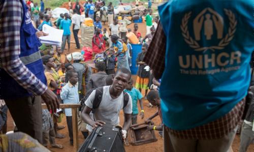 A recently arrived South Sudanese refugee loads his belongings into a UNHCR truck at the South Sudan border with Uganda. Photo: UNHCR/Will Swanson