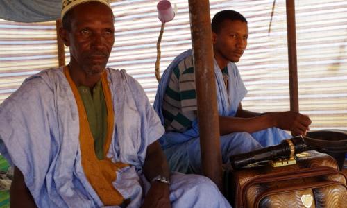 Sow, à gauche, un réfugié malien, est récemment arrivé avec son fils au camp de Mbera en Mauritanie. Ils n’ont pas encore déballé eurs valises.   © HCR / Sebastien Laroze-Barrit