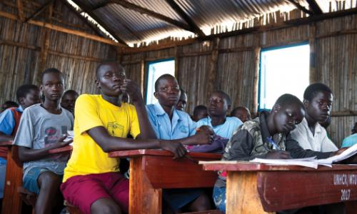 Refugee students in a classroom in Uganda. Photo: UN Photo/Mark Garten