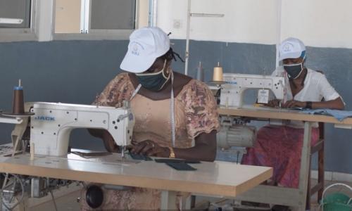 Young tailors in Guinea stitching masks