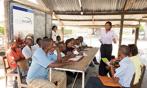 A MicroEnsure agent talks to microfinance clients about microinsurance at a group meeting in Nairobi, Kenya.  Alamy/David Dorey