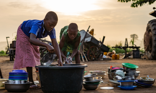 Girls washing dishes in Lome, Togo.