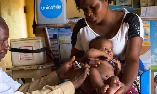 A mother holds her 3-month-old baby as he receives a vaccination against measles at a health centre in Lubumbashi, Democratic Republic of the Congo.