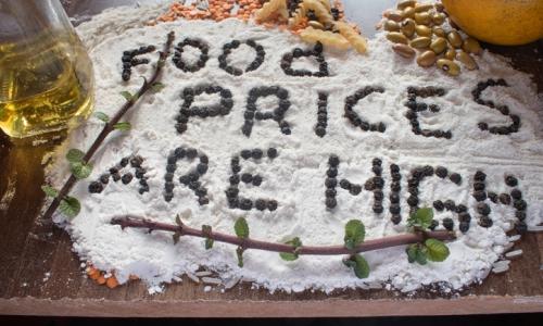Spelled out with black pepper seeds on a flour with lentils and other food in the background.