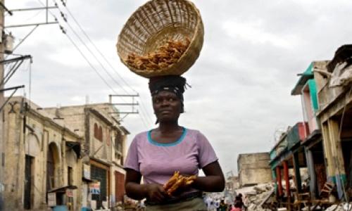 A woman walking through the rubble in downtown Port au Prince