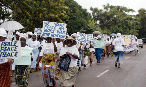 Liberian women marching through the streets of Monrovia agitating for peace.