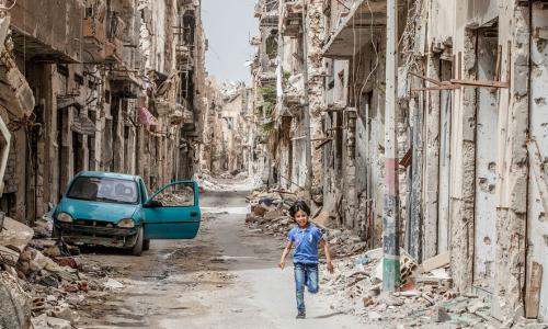 A child runs through the debris and wreckage in downtown Benghazi, Libya.