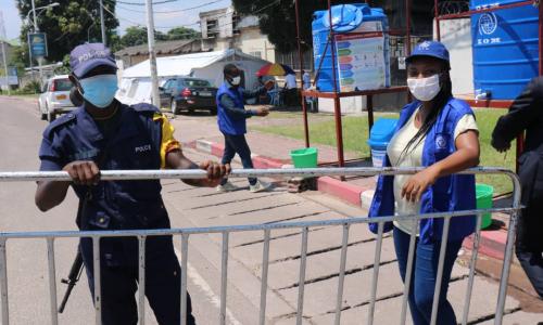 IOM staff stand ready to supervise COVID-19 preventive measures activities at a point of control in Kinshasa, Democratic Republic of the Congo.