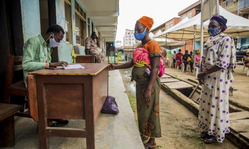 Women in Nigeria collect food vouchers as part of a programme to support families in difficulty