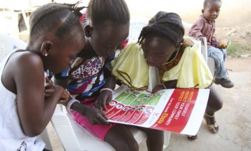 Girls in Voinjama, Liberia, look at a poster that displays information on Ebola.   Photo: UNICEF/Liberia/Jallanzo