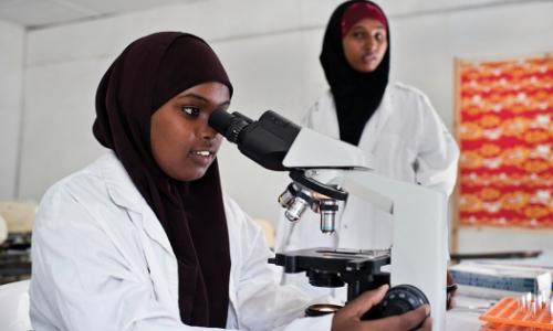 Young women study in a science laboratory at Mogadishu University, Somalia. Photo: Panos/Sven Torfinn