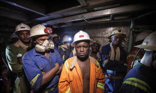 Miners in a lift cage at the Chambishi copper mine in Kitwe, Zambia. Photo: Panos/Sven Torfinn