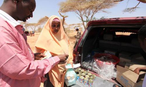 Mama akinunua samaki wa mkebe kwa vocha cha WFP Burao, Kaskazini mwa Somalia.
