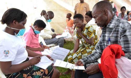 Health workers receiving members of the public for TB screening in Uganda.