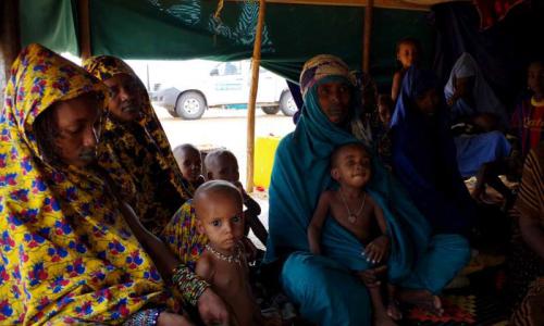 New arrivals from Mali sit inside one of the tents at Mbera Camp, some 50 kilometres inside Mauritania