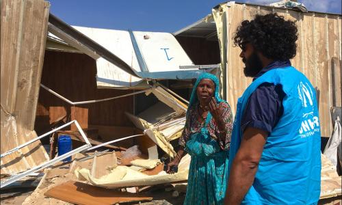 A woman stands in front of her home, which was demolished by local militia during violence in Tripoli. Many people, forced to flee their homes, are returning after the ceasefire. Photo credits: UNHCR/Tarik Argaz