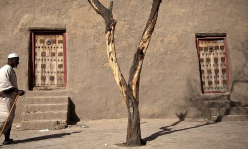 A resident walks past Djingareyber Mosque in Timbuktu, Mali.