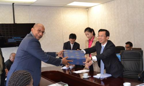 Dr Mayaki and Ambassador Shaye exchanging gifts