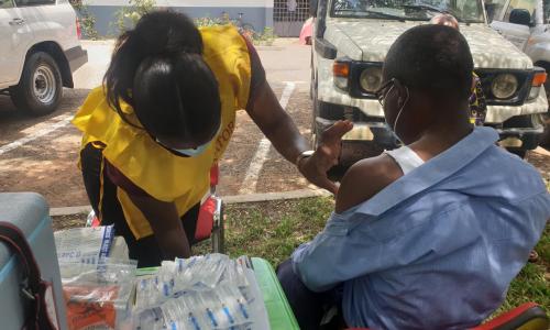 Health worker vaccinating a client in the Kumasi in the Ashanti Region of Ghana