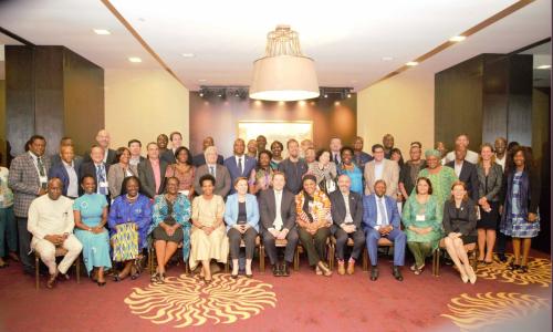 UNDP Administrator Achim Steiner, seated, at center in group photo with around 40 people.