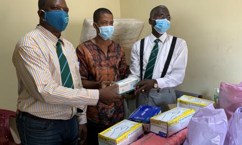 Dr. Mamadu Baldeh (center) receiving Personal Protective Equipments (PPEs)
