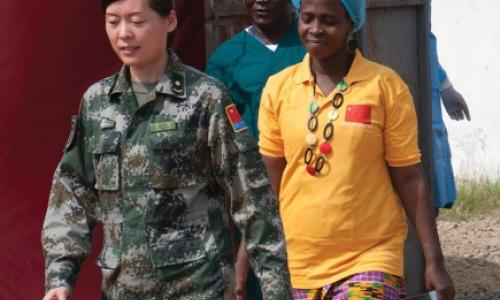 Beatrice Yardolo, right, Liberia’s last Ebola patient, walks out of the Chinese Ebola Treatment Unit (ETU) in Monrovia, Liberia, at the beginning of a short ceremony celebrating her survival and release from the ETU on March 5. Photo: UNMEER/Simon Ruf